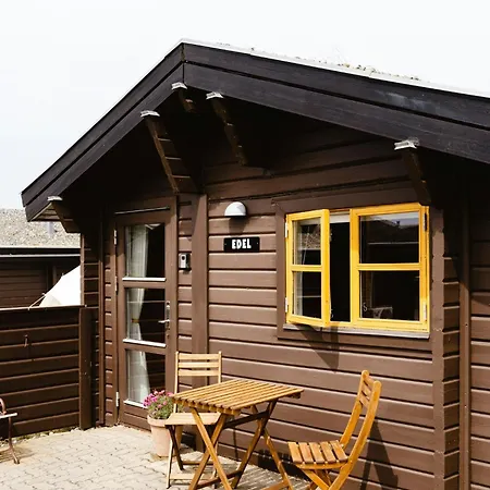 A Small Wooden Hut In A Large Community
