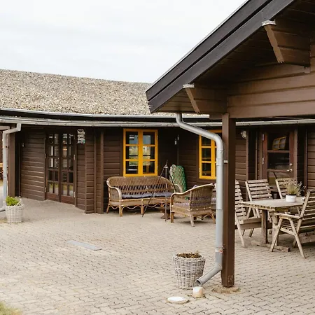 A Small Wooden Hut In A Large Community